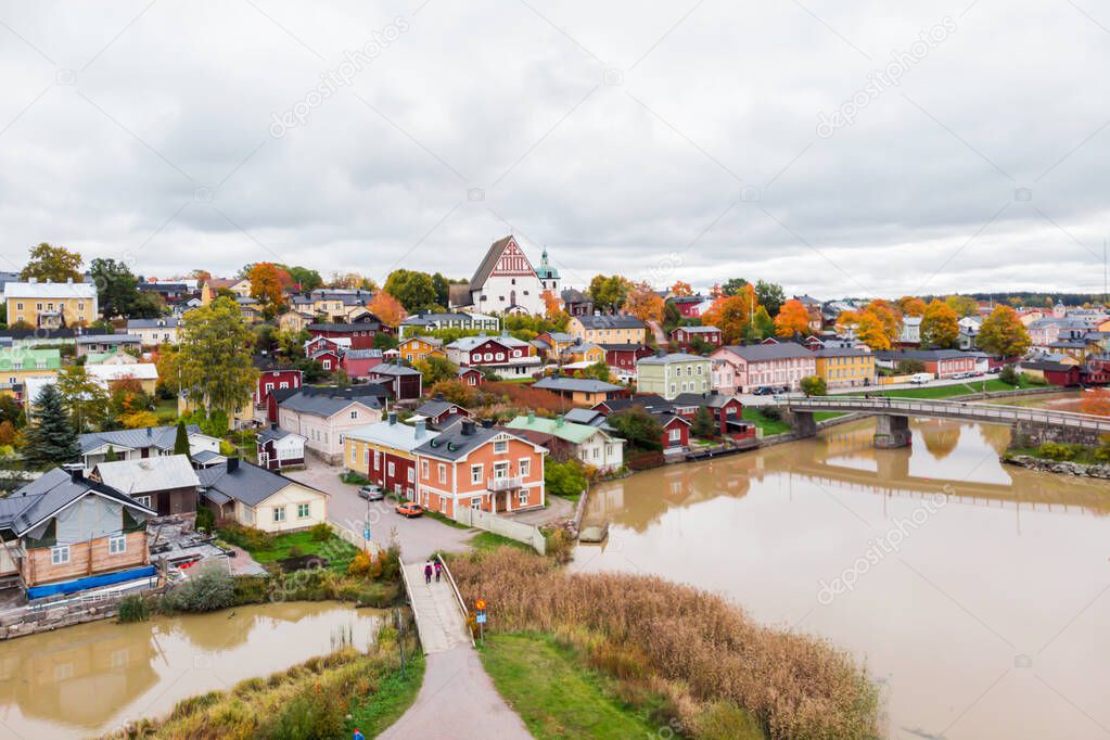 Aerial autumn view of Old town of Porvoo, Finland. Beautiful city landscape with idyllic river Porvoonjoki, old colorful wooden buildings and Porvoo Cathedral.
