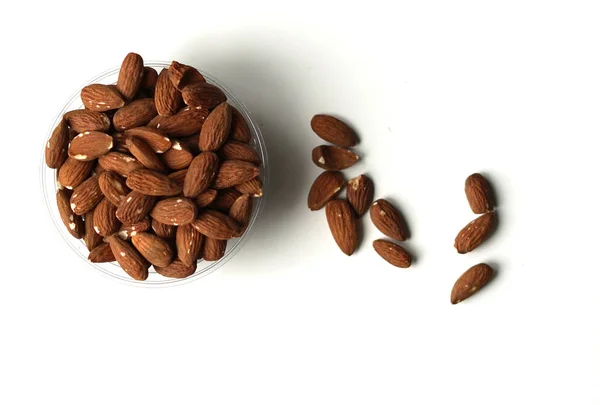 Healthy food  for background image close up almond nuts. Texture on white grey table top view. Nuts on the cup plate — Stock Photo, Image