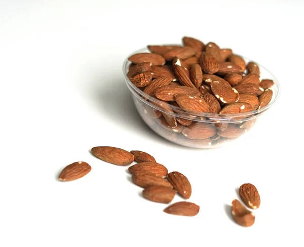 Healthy food  for background image close up almond nuts. Texture on white grey table top view. Nuts on the cup plate — Stock Photo, Image