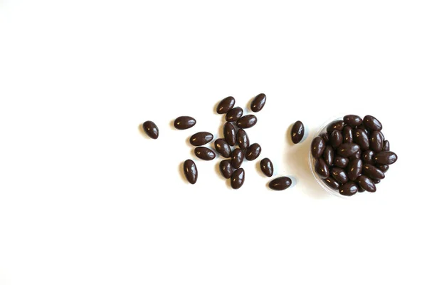 Food image close up candy, chocolate milk, extra dark almond nuts. Love Texture on white grey table top view background on the cup plate — Stock Photo, Image