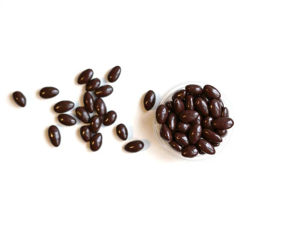 Food image close up candy, chocolate milk, extra dark almond nuts. Love Texture on white grey table top view background on the cup plate — Stock Photo, Image