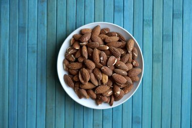 Arka plan görüntüsü için sağlıklı gıda kadar badem fındık kapatın. Doku fındık Kupası plaka üzerinde