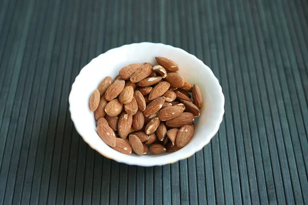 Arka plan görüntüsü için sağlıklı gıda kadar badem fındık kapatın. Doku fındık Kupası plaka üzerinde