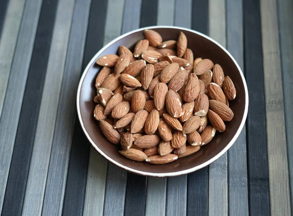 Healthy food  for background image close up almond nuts. Texture Nuts on the cup plate — Stock Photo, Image