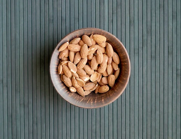 Arka plan görüntüsü için sağlıklı gıda kadar badem fındık kapatın. Doku fındık Kupası plaka üzerinde