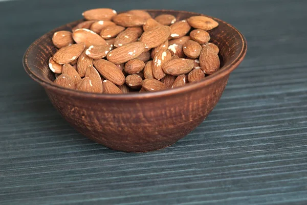 Healthy food  for background image close up almond nuts. Texture Nuts on the cup plate — Stock Photo, Image