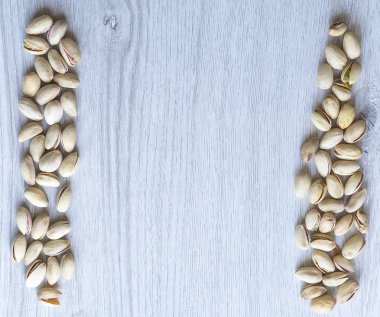 Arka plan görüntüsü için sağlıklı gıda antep fıstığı kapatın. Üst görünümde Doku Somunları sahte