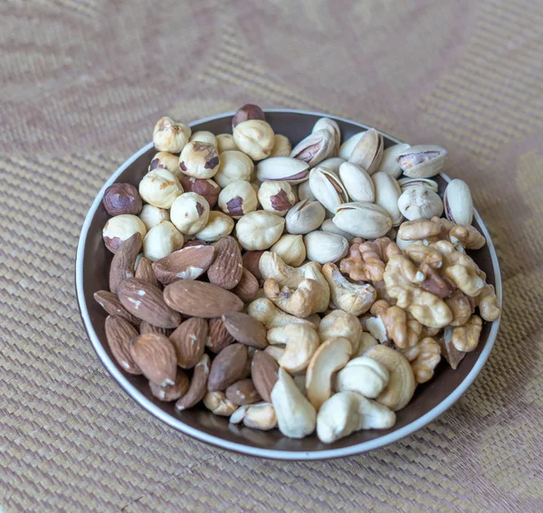 Healthy food. Nuts mix assortment on stone texture top view. Collection of different legumes for background image close up nuts, pistachios, almond, cashew nuts, peanut, walnut. image