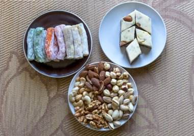 Traditional Turkish Delight. Oriental dessert halva on a  plate. Isolated on background. Eastern delicacy sweets. Healthy food. Nuts mix assortment. Collection of different legumes for image close up nuts, pistachios, almond, cashew nuts, peanut, wal clipart