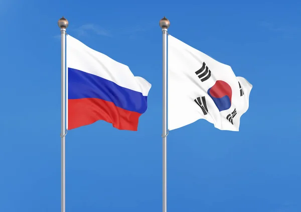 俄罗斯 俄罗斯和韩国的厚彩色丝绸国旗 天空背景上的 — 图库照片