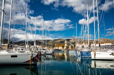 Resting yachts stays in the Trogir's harbor. clipart