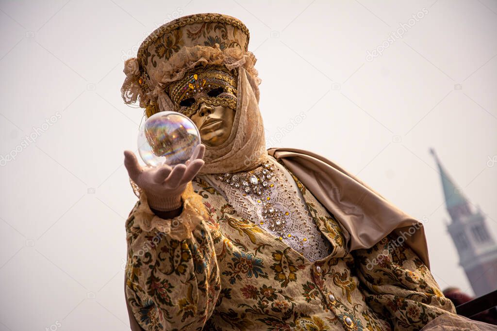 Golden mask with glass sphere at Venice Carnaval.