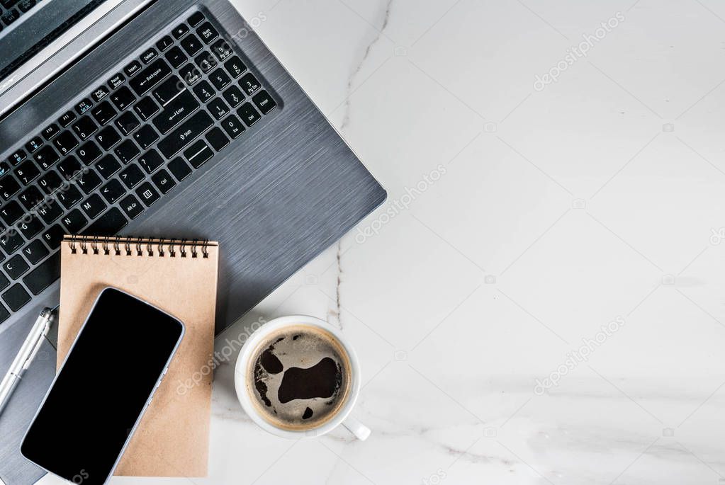 Workplace, white desk table with laptop, smartphone, coffee cup and notepad, Top view with copy space