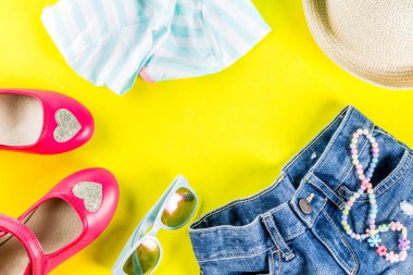 Yaz tatil kavramı, yaz çocuk bezi seti - çocuklar şort, tişört, şapka, güneş gözlüğü, bilezik kolye, spor ayakkabıları, parlak sarı arka plan düz yatıyordu kopya alanı üstüne