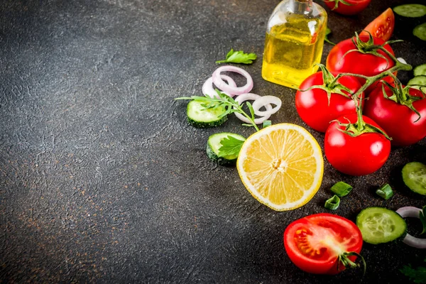 Cooking background, fresh salad ingredients, italian cuisine - tomatoes, olive oil, lemon, cucumbers, arugula, parsley, onions, Dark rusty background copy space