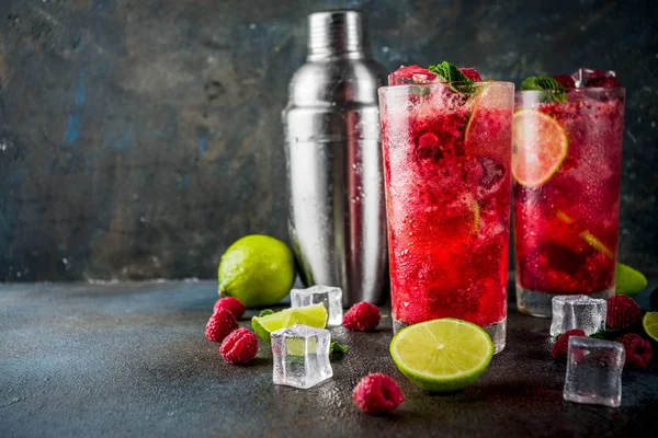 stock image Iced summer drink cocktail, Raspberry and lime lemonade with fresh mint and lime, dark blue rusty background copy space