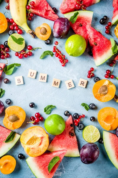 Summer vitamin food concept, various fruit and berries watermelon peach mint plum apricots blueberry currant, creative flat lay on light blue background top view copy space