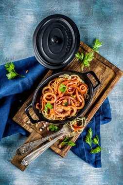 İtalyan mutfağı, kalamar Fra Diavolo, spagetti makarna ile deniz ürünleri, açık mavi renkli kopya alanı üstten görünüm marinara