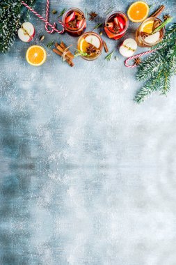 Geleneksel kış içecekler, beyaz ve kırmızı mulled şarap kokteyl ile beyaz ve kırmızı şarap, baharat, elma, portakal. Üzerinde mavi masa lambası,