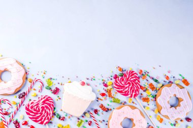Tatlılar yaratıcı paralamak, lolipop, reçel, şeker, çerezleri çörek ve cupcakes, açık mavi renkli üstten görünüm kopya alanı ile tatlı kavramı