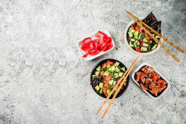 Asian trendy food, sushi poke bowl with cucumber, salmon, avocado, Black and White Sesame Seeds  