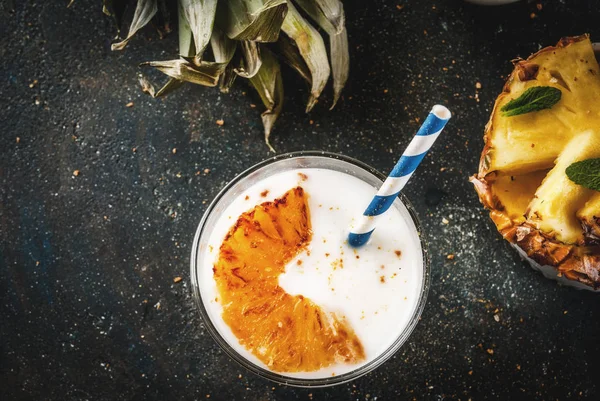 Indian food and drink, Caramelized Pineapple Lassi cocktail, dark blue background copy space top view