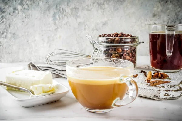 Trendy ketogenic diet food, Bulletproof coffee with milk and butter, white marble background copy space