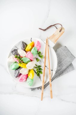 Traditional Chuseok day food, Korean Half-moon Shaped Rice Cake Songpyeon, white marble background copy space top view clipart