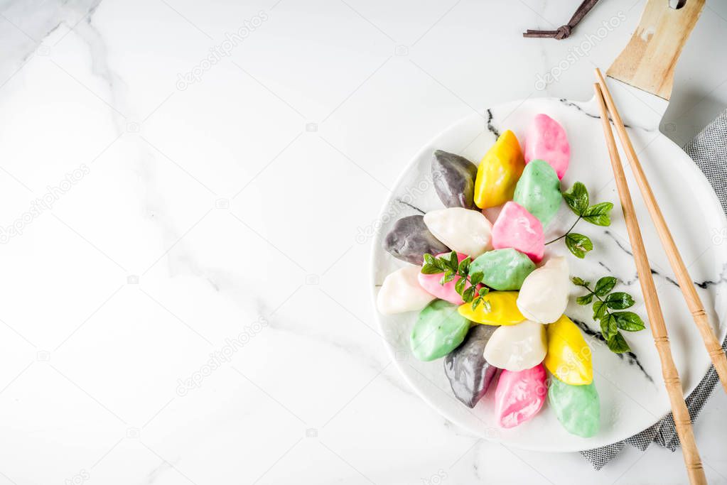 Traditional Chuseok day food, Korean Half-moon Shaped Rice Cake Songpyeon, white marble background copy space top view