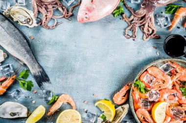 İstiridye midye balık baharat otlar limon, açık mavi renkli kopya alanı üstten görünüm çerçeve ile taze çiğ deniz mahsulleri kalamar karides