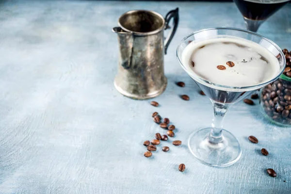 Coffee drink ideas, espresso martini cocktail, two glasses on blue concrete background copy space