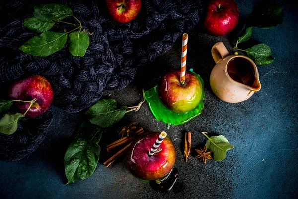 Geleneksel sonbahar incelik, karamelli elma sır. Karanlık bir arka plan üzerinde elma, yaprak, karamel sos ve sıcak bir battaniye ile. Metin için yer kopyalayın