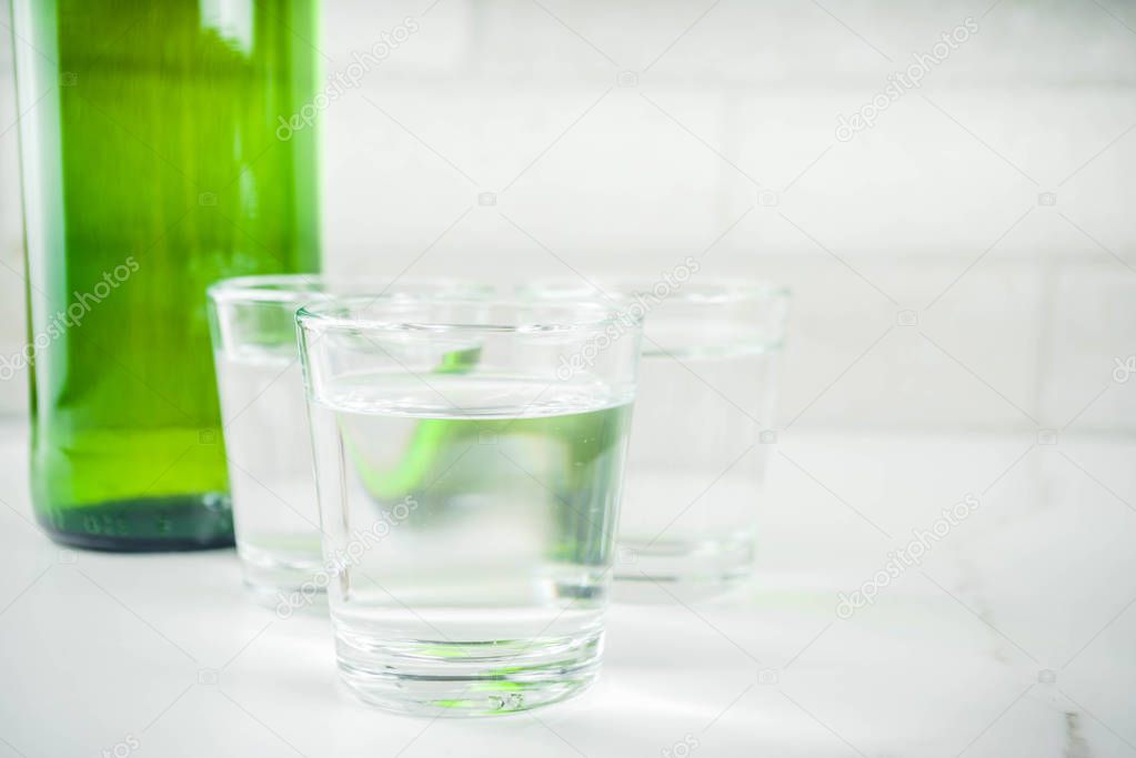 Traditional korean alcohol drink soju on light concrete background copy space
