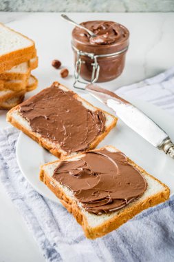 Çikolata ve fındıklı sandviç, kızarmış ekmek, beyaz mermer arka plan fotokopi alanı.