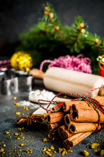 Christmas bakery background, with baking utensils, flour, spices and decorations, dark concrete table, copy space top view
