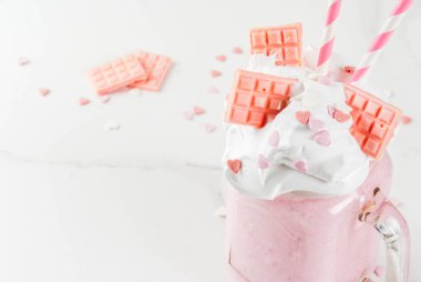 Crazy shake, romantic milkshake for Valentine's day with strawberry, white chocolate and sugar candy hearts, on white background, copy space clipart