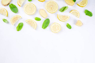 Mojito, limonata kokteyl veya ekşi infüzyon su madde. Dilimlenmiş limon, zencefil ve nane yaprakları, beyaz arka plan üstten görünüm kopya alanı düzeni ile Flatlay