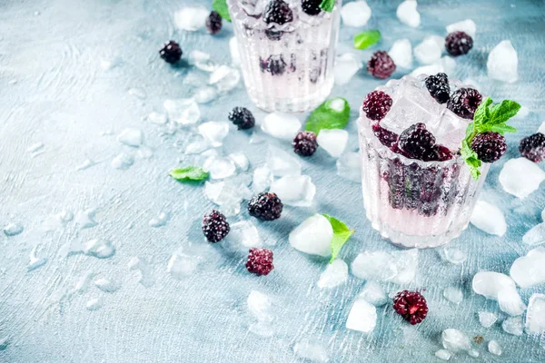 Homemade blackberry lemonade on light blue concrete background copy space