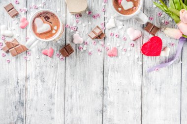 Sevgililer günü fikirleri tedavi eder, iki fincan sıcak çikolata ile marshmallow kalpleri ile kırmızı pembe beyaz çikolata parçacıkları, şeker parçacıkları, eski ahşap arka plan fotokopi alanı üst görünümü