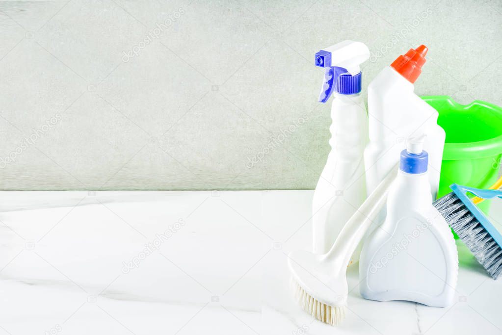 Cleaning concept with different cleaning supplies, on gray stone concrete background copy space