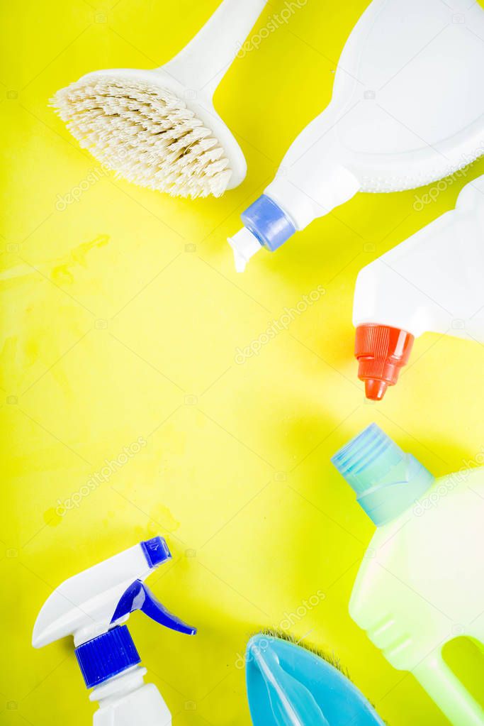 Cleaning concept with different cleaning supplies, on bright yellow background top view, copy space