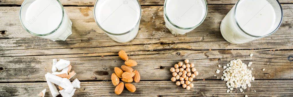plant based vegan food and drink, Non-dairy milk and cheese tofu - from almond, nuts, soy beans, oats and coconut, wooden background copy space banner