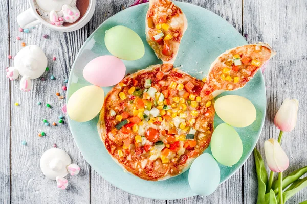 Funny easter food, ideas recipes for children Easter party, healthy  kids pizza with vegetables, top view copy space