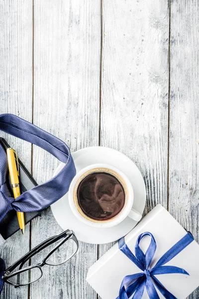 Fathers day greeting background with coffee cup and presents on wooden table copy space top view