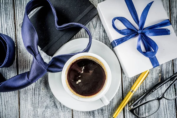 Fathers day greeting background with coffee cup and presents on wooden table copy space top view