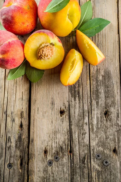 stock image Fresh organic peaches  on rustic wooden table