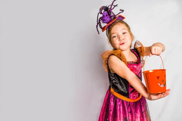 Kicsi aranyos lány boszorkányjelmezben Halloweenkor — Stock Fotó