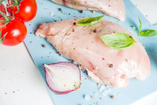 Raw chicken fillet with spices and herbs