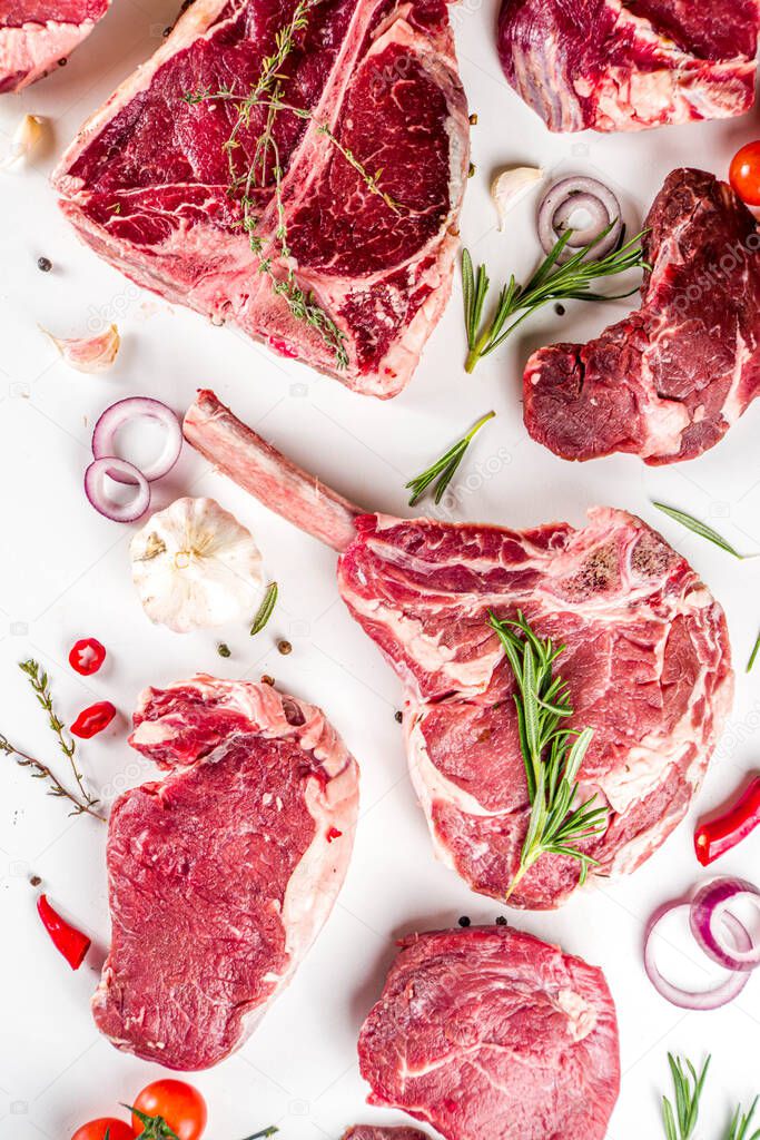 Set of various classic, alternative raw meat, veal beef steaks - chateau mignon, t-bone, tomahawk, striploin, tenderloin, new york steak. Flat lay top view on white table background