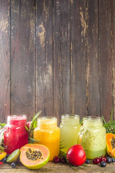 Stock image Assorted different fruit smoothies and juices with tropical fresh fruits and berries. Clean eating, healthy lifestyle, diet and vitamin drink beverages concept. Top view flatlay white table background 